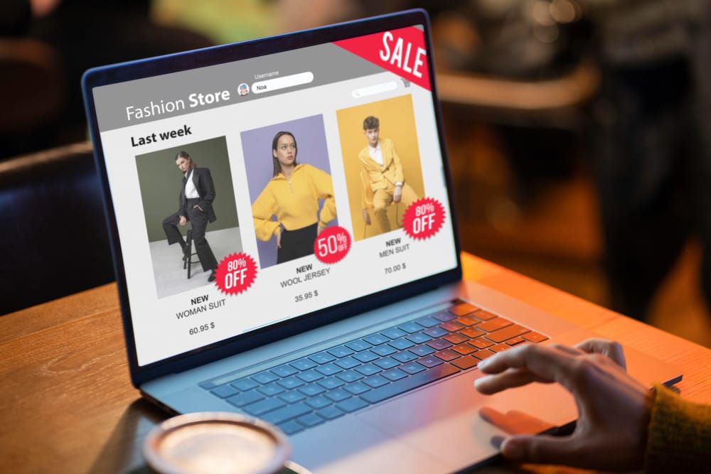 An e-commerce fashion store website shown on a laptop
